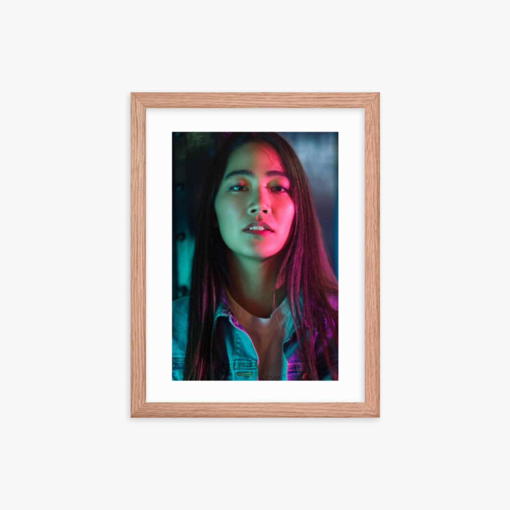 Portrait of young woman lit by colorful neon lights at night 12x16 in Poster With Oak Frame