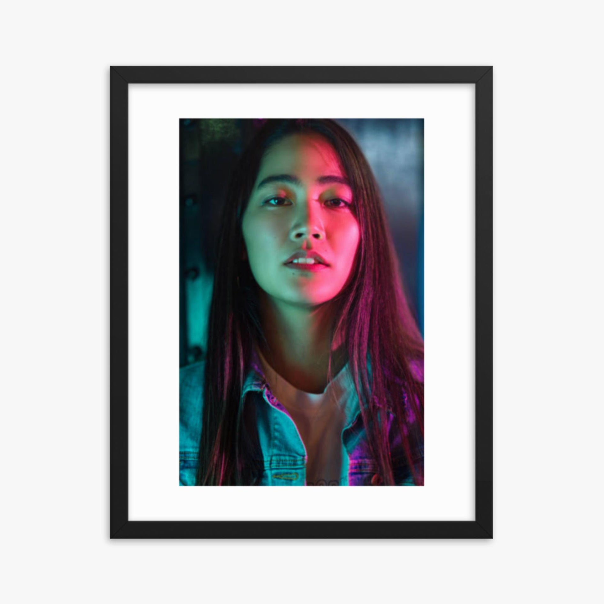 Portrait of young woman lit by colorful neon lights at night 16x20 in Poster With Black Frame