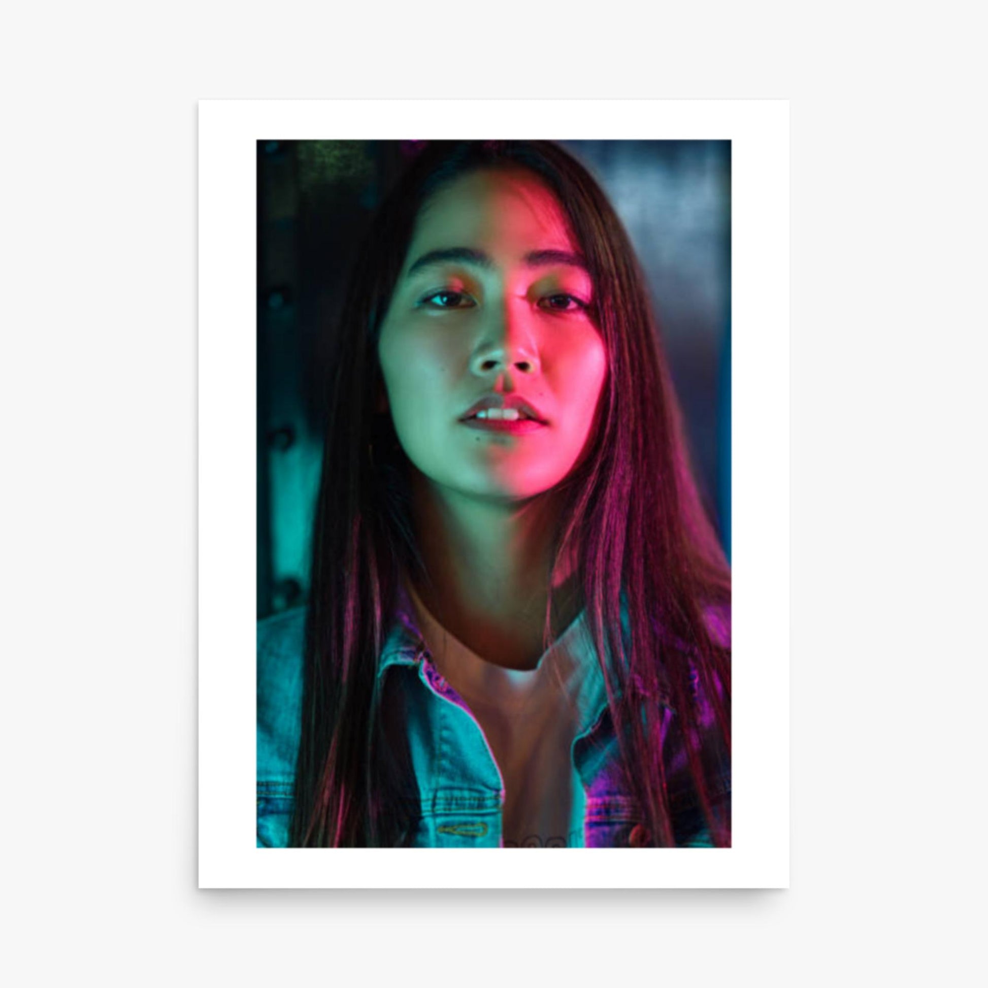 Portrait of young woman lit by colorful neon lights at night 18x24 in Poster